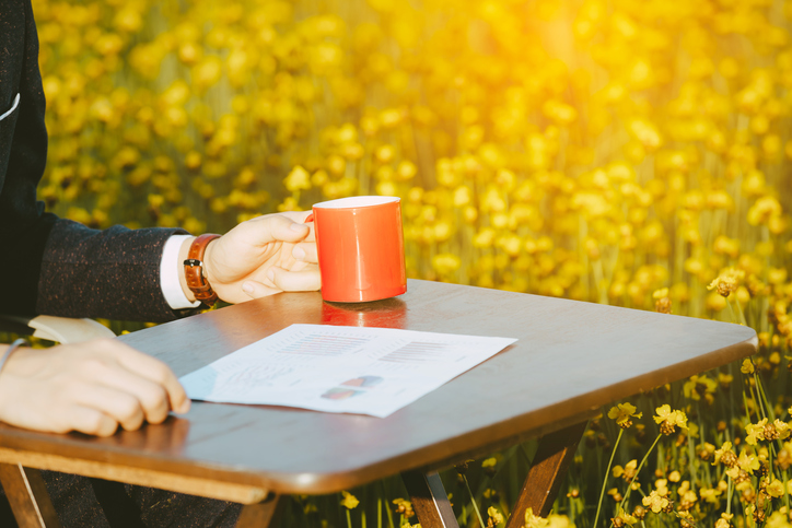 businessman drinking coffee and looking chart