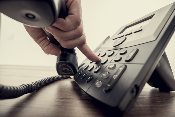 Male hand holding telephone receiver